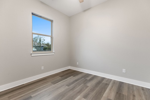 empty room with hardwood / wood-style flooring and ceiling fan