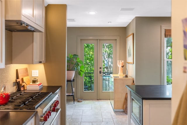 kitchen with french doors, appliances with stainless steel finishes, and a healthy amount of sunlight