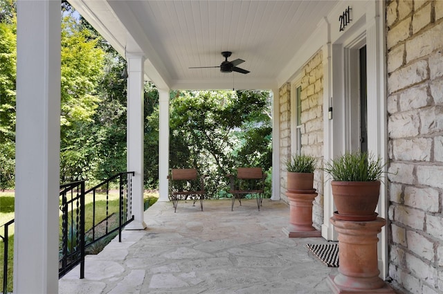 view of patio featuring ceiling fan and a porch