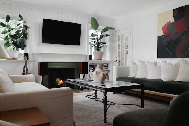 living room with a fireplace and ornamental molding