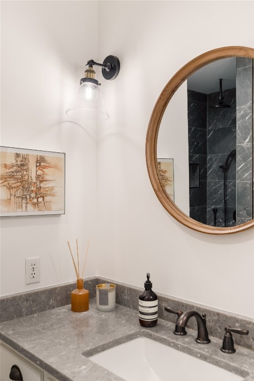 details featuring vanity and a tile shower