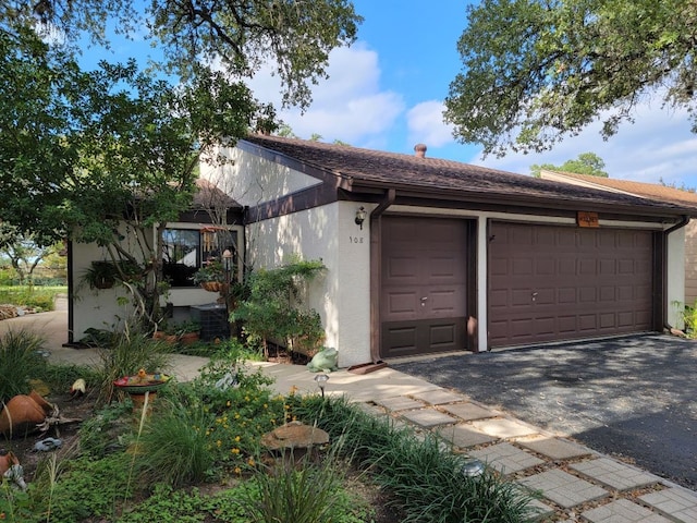 108 Overlook Cir, Wimberley, TX 78676 - exterior space featuring a garage, stucco siding, and central AC