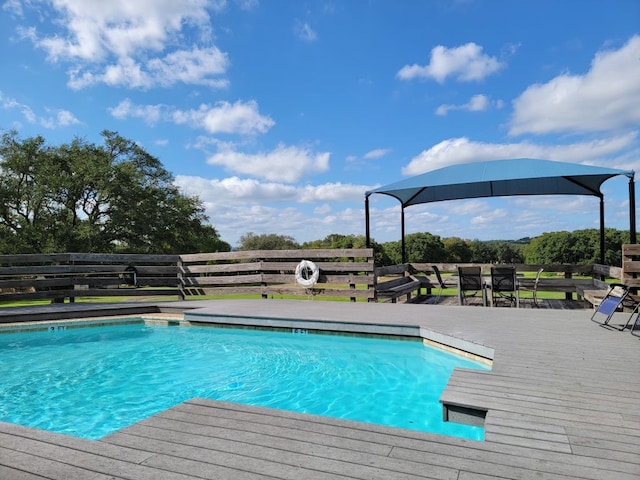 view of swimming pool with a deck