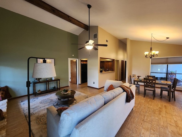 living room with light wood-type flooring, ceiling fan with notable chandelier, high vaulted ceiling, and beam ceiling