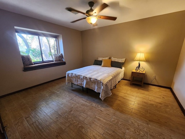 bedroom featuring ceiling fan and hardwood / wood-style floors