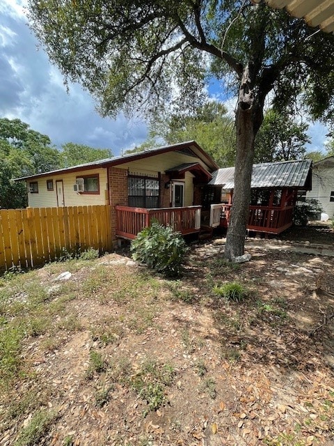 back of house with a wooden deck