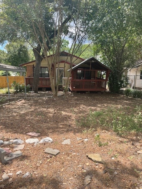 view of yard with a wooden deck and a carport