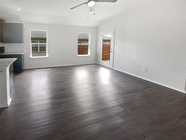 unfurnished living room with ceiling fan and dark hardwood / wood-style flooring