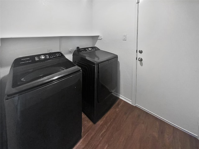 washroom with dark hardwood / wood-style floors and independent washer and dryer