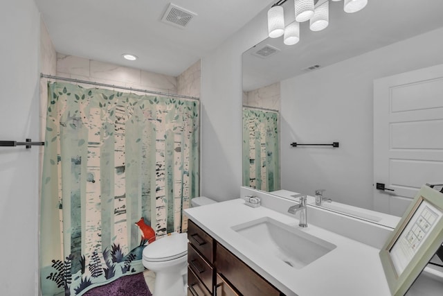 bathroom featuring vanity, toilet, and a shower with shower curtain