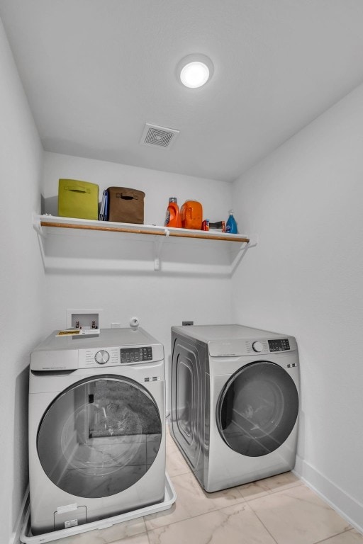 laundry area with washing machine and clothes dryer