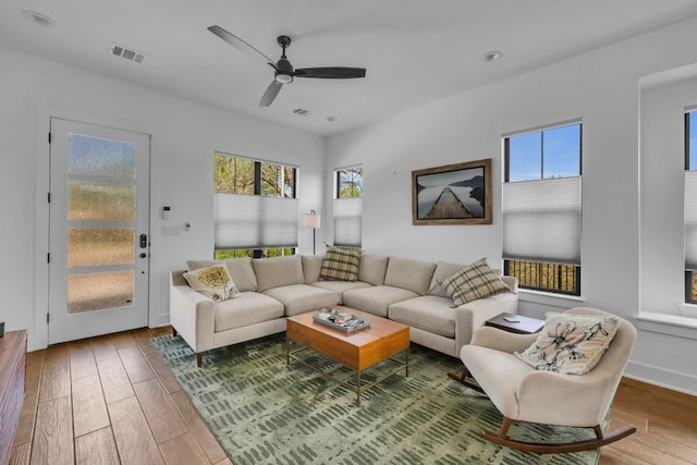 living room with ceiling fan and hardwood / wood-style floors