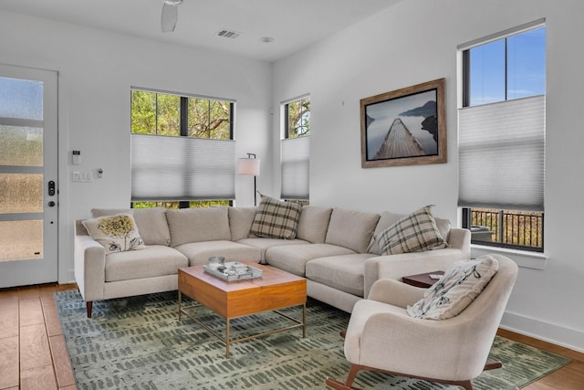 living room featuring ceiling fan and wood-type flooring