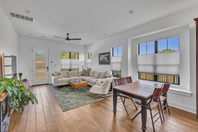 living room with light hardwood / wood-style flooring and ceiling fan