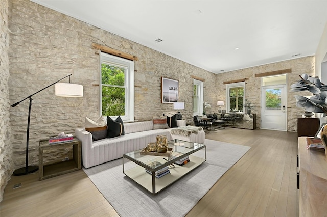 living room featuring a healthy amount of sunlight and light hardwood / wood-style flooring