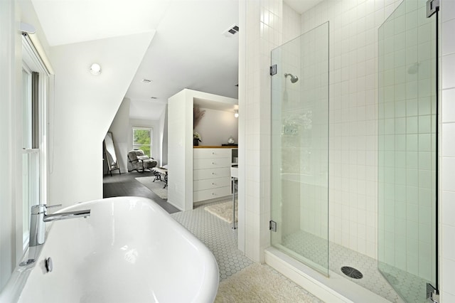 bathroom with vaulted ceiling, plus walk in shower, and tile patterned floors