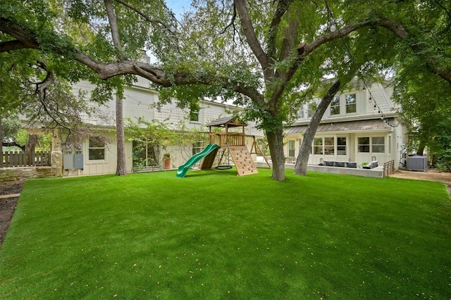 view of yard with a playground and central air condition unit