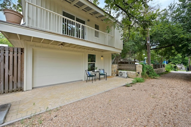 back of house featuring a balcony and a patio area