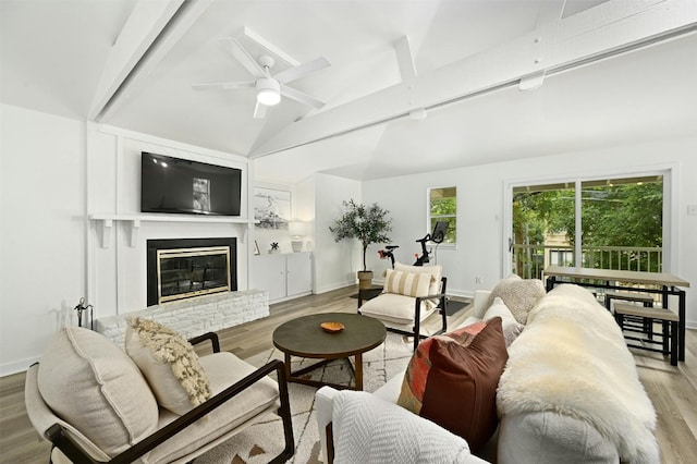 living room featuring light wood-type flooring, lofted ceiling, and ceiling fan