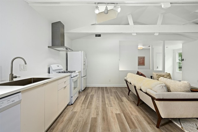 kitchen featuring white cabinets, sink, white appliances, wall chimney range hood, and lofted ceiling with beams