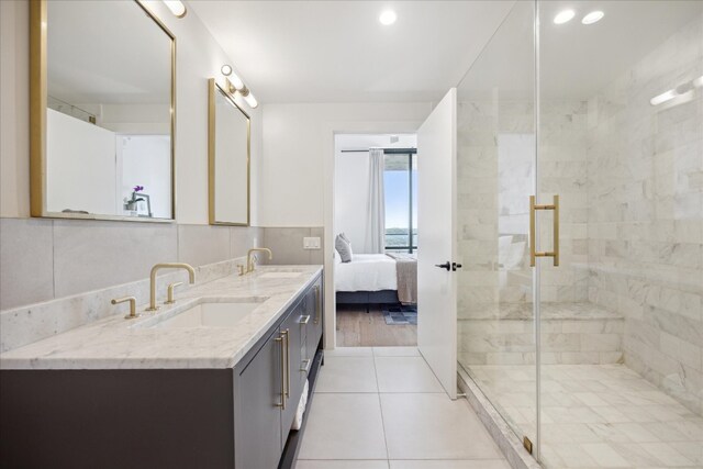 bathroom with vanity, tile walls, wood-type flooring, and walk in shower