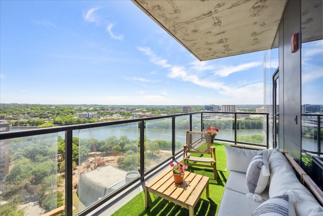 balcony with an outdoor hangout area and a water view