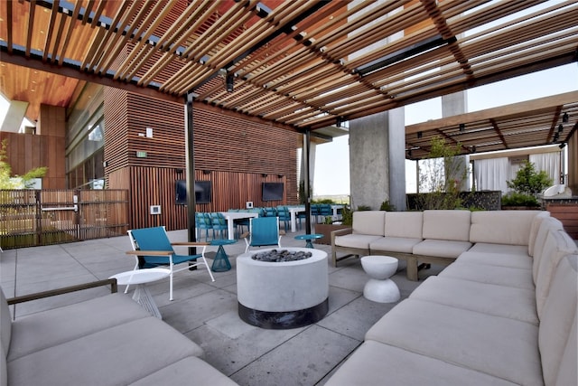 view of patio / terrace featuring an outdoor living space with a fire pit and a pergola