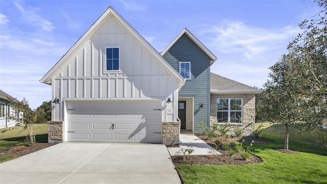 view of front facade with a front yard and a garage