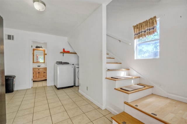 staircase featuring washer and clothes dryer and tile patterned flooring