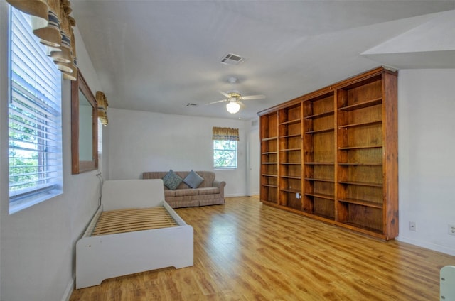 living room featuring light wood-type flooring and ceiling fan