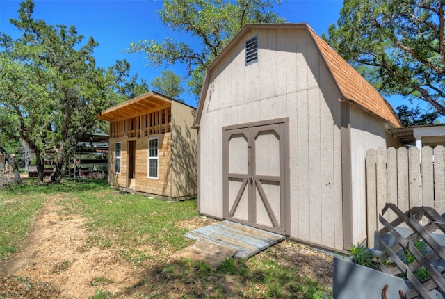 view of outbuilding featuring a lawn