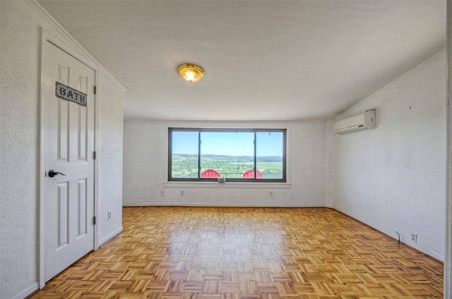 spare room featuring crown molding, light parquet floors, and an AC wall unit