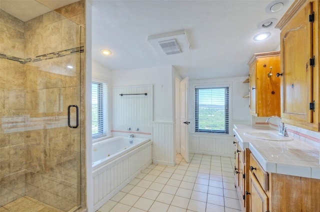 bathroom featuring plus walk in shower, tile patterned floors, and vanity