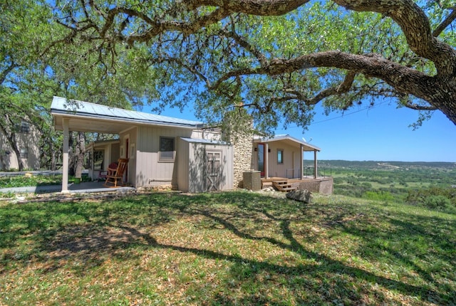 back of house featuring a lawn and a patio area