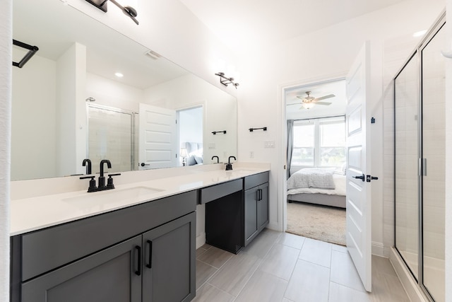 bathroom featuring ceiling fan, vanity, and an enclosed shower