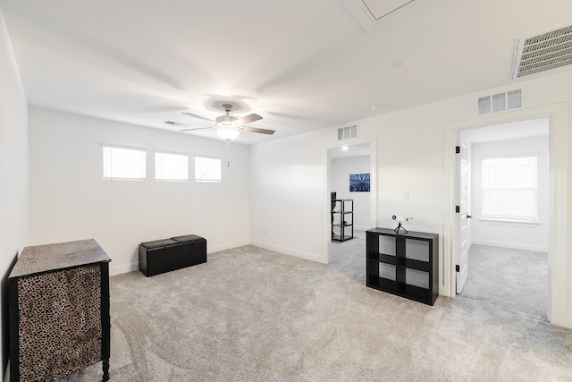 sitting room featuring light colored carpet and ceiling fan