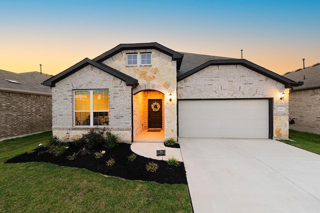 view of front facade with a lawn and a garage