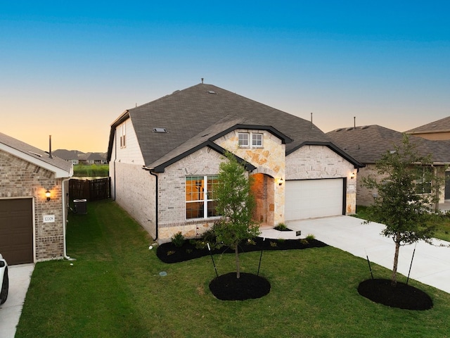 view of front facade with a lawn and a garage