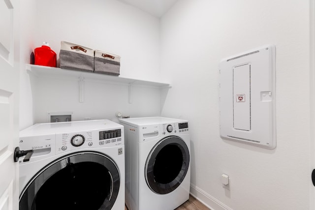 washroom featuring separate washer and dryer and hardwood / wood-style flooring