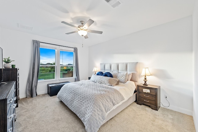 bedroom featuring ceiling fan and light carpet