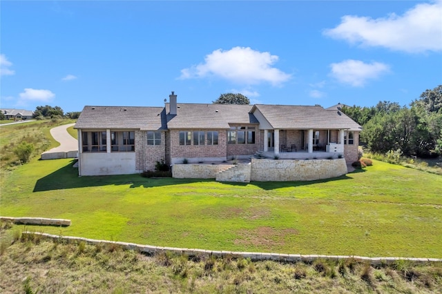 rear view of property with a yard