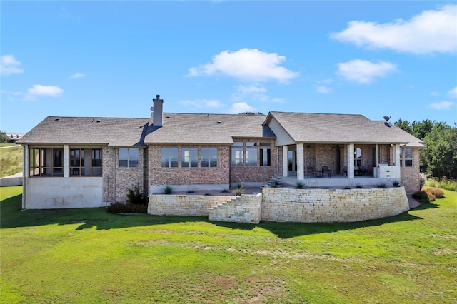 back of property featuring a lawn and a patio area