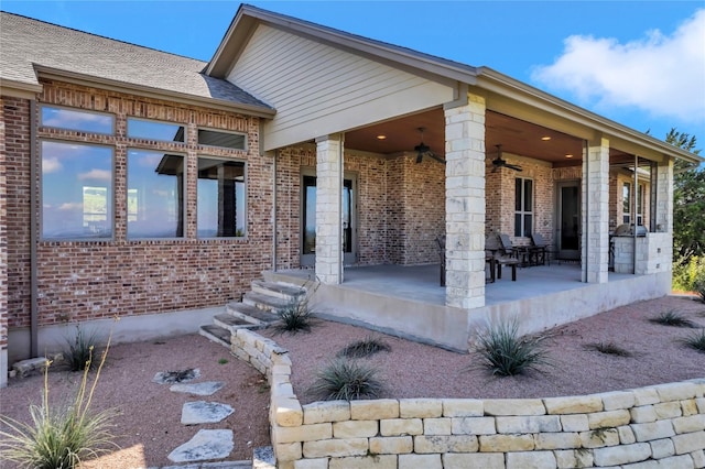 back of house with ceiling fan and a patio area