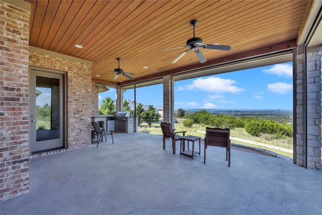 view of patio with ceiling fan, grilling area, and an outdoor kitchen