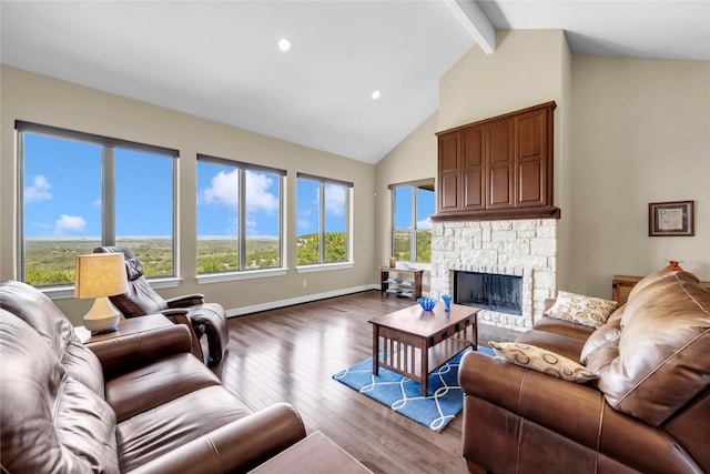 living room with hardwood / wood-style flooring, a fireplace, lofted ceiling with beams, and a wealth of natural light