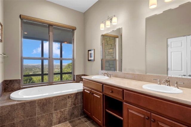 bathroom with vanity and a relaxing tiled tub