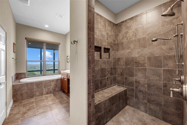 bathroom featuring vanity and plus walk in shower