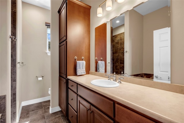 bathroom featuring tile patterned flooring, vanity, and toilet