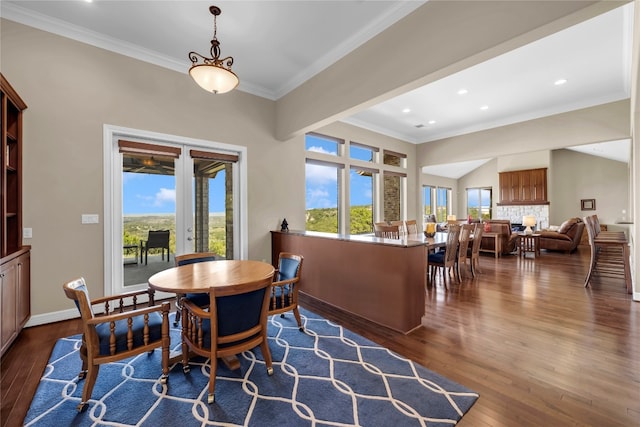 dining area featuring ornamental molding and dark hardwood / wood-style flooring