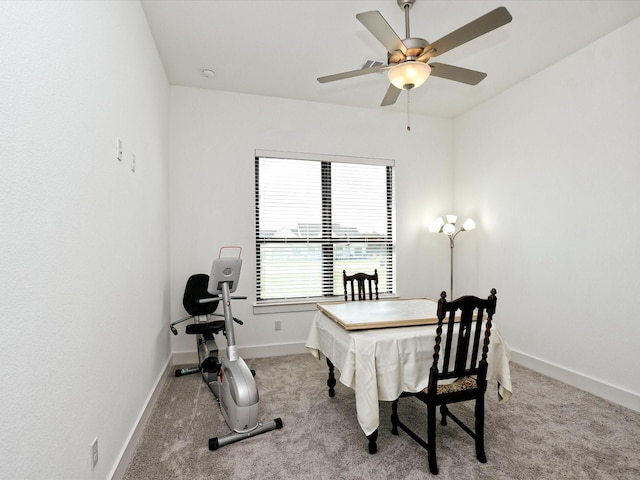 carpeted dining space featuring ceiling fan